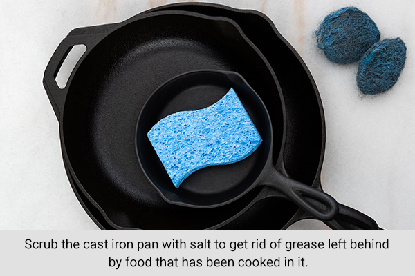 scrubbing the cast iron pan can help get rid of grease left behind by food