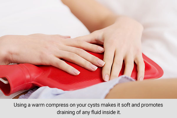 apply a warm compress to reduce signs of vaginal cysts