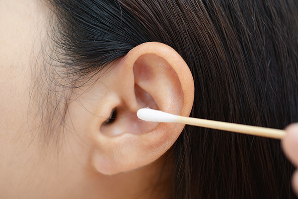 why does earwax accumulate in your ear?
