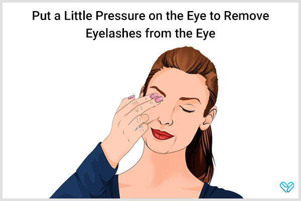 carefully apply a little pressure on the eye to remove stuck eyelashes